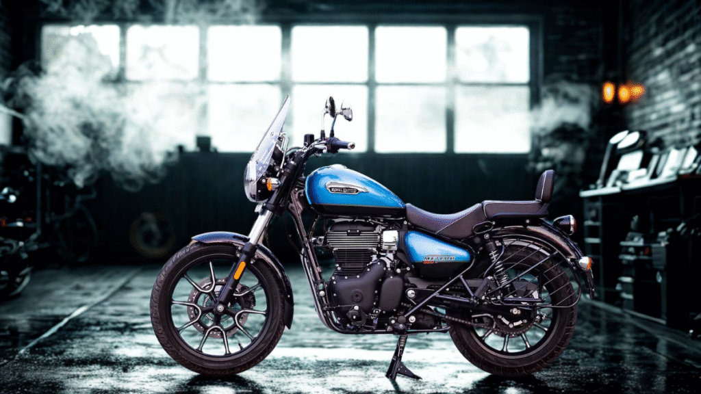 Royal Enfield Meteor 350 in Stellar Blue parked on an empty forest road with foggy trees in the background — a cruiser motorcycle built for serene highway rides.