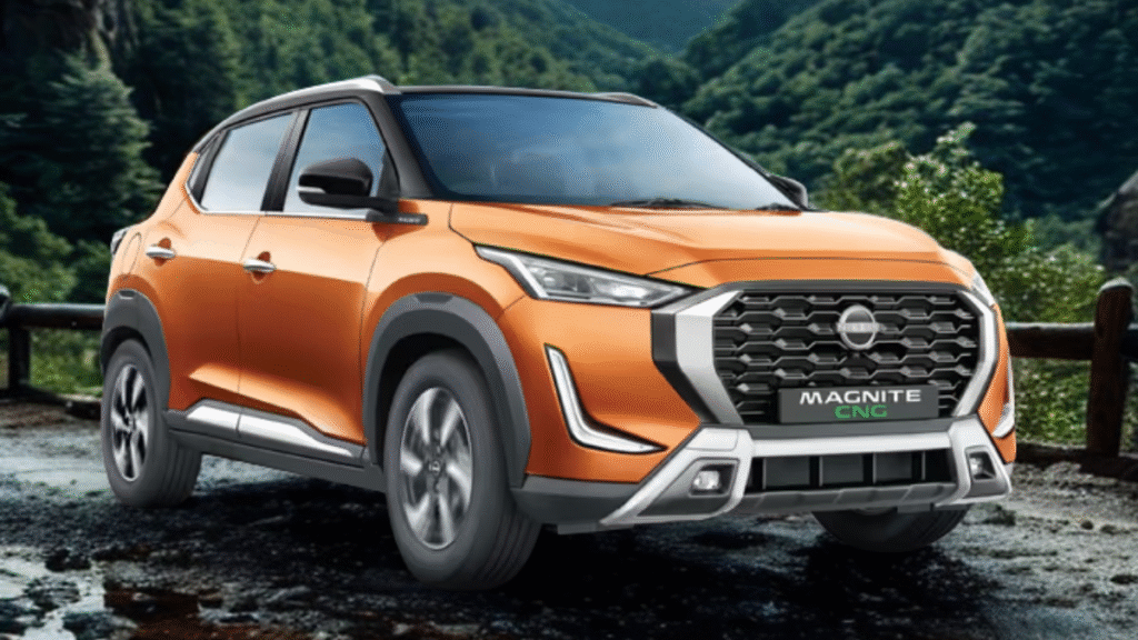 Orange Nissan Magnite CNG parked on a mountain road, showcasing its sleek design and eco-friendly appeal.