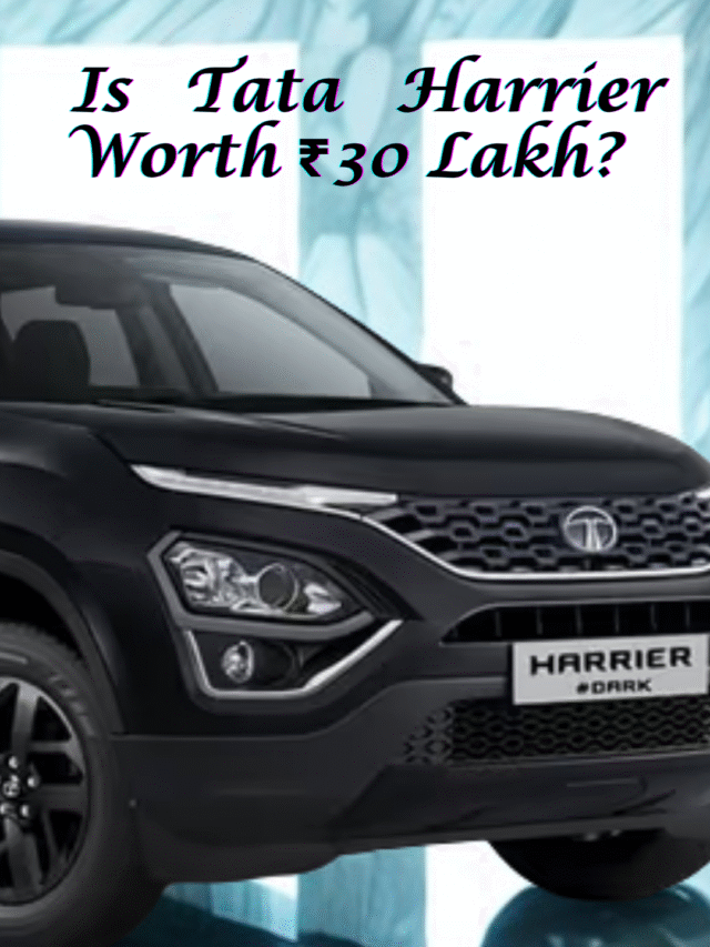 Tata Harrier Dark Edition parked on a modern city road at night with glowing streetlights highlighting its bold design.