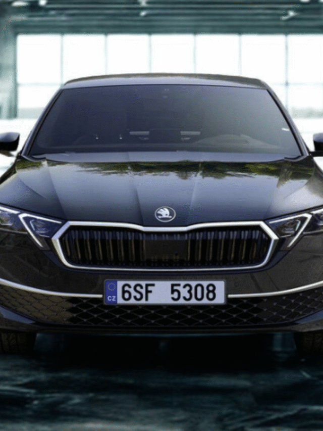 Front three-quarter view of the Skoda Octavia RS showing bold grille and Matrix LED headlights on a scenic road