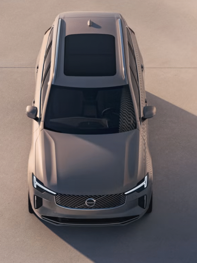 A sleek Volvo XC90 driving through a scenic mountain road, highlighting its premium SUV design and safety features.