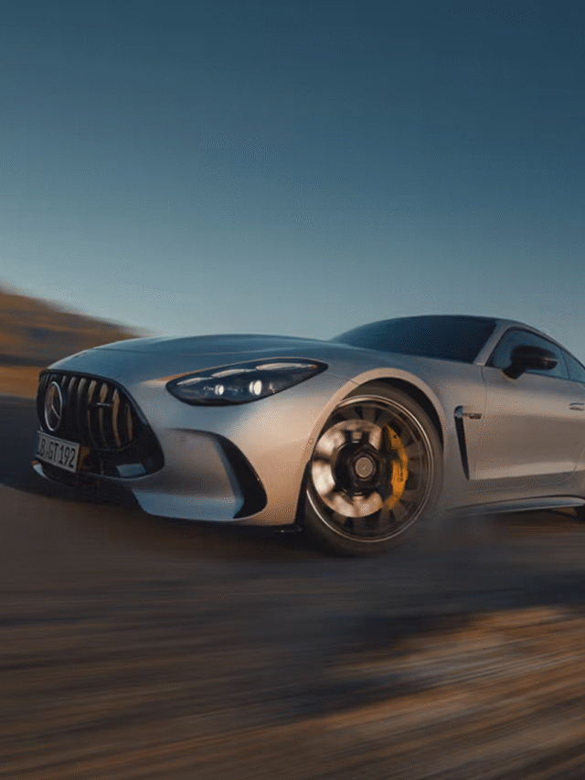 Front view of the Mercedes-AMG GT Coupé driving through a scenic European mountain road